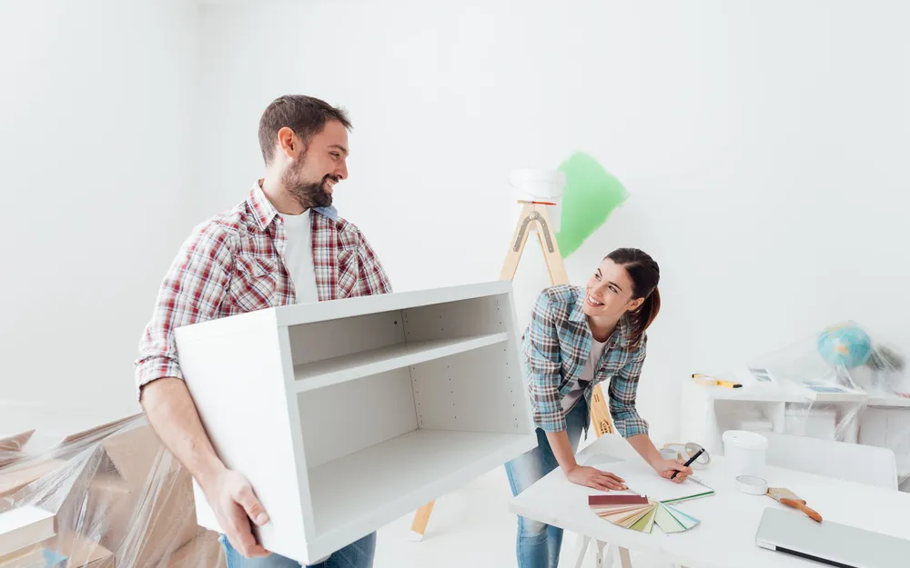 Young,Happy,Couple,Renovating,Their,New,House,And,Moving,Furnishings