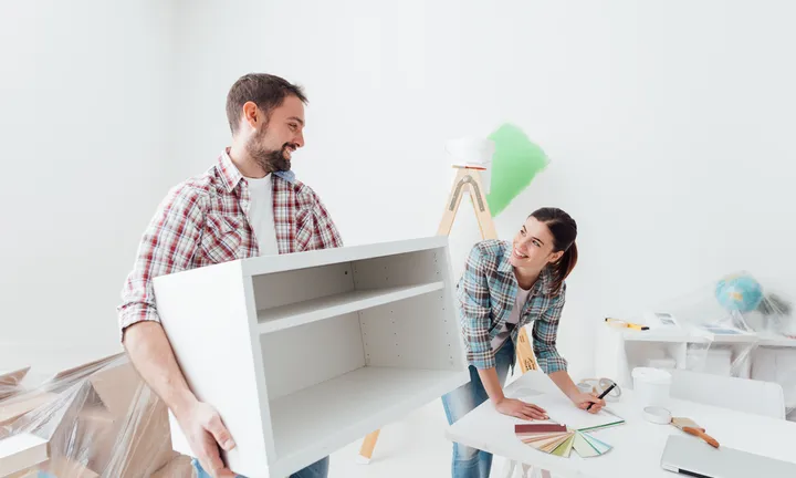 Young,Happy,Couple,Renovating,Their,New,House,And,Moving,Furnishings